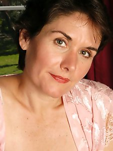 An elderly whore is posing without clothes on the camera