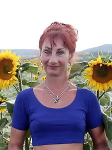 Aged girlfriend is posing undressed on the street